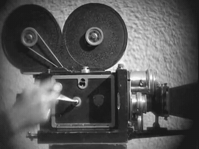 A Black And White Photo Of A Person Using A Film Camera . GIF