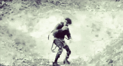 A Black And White Photo Of A Person Walking GIF
