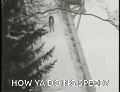A Black And White Photo Of A Person Walking Down A Snowy Path . GIF