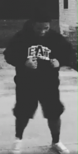 A Black And White Photo Of A Person Wearing A Hoodie That Says Eat . GIF