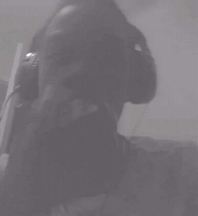 A Black And White Photo Of A Person Wearing Headphones With Their Eyes Closed GIF