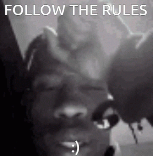 A Black And White Photo Of A Person With A Smiley Face On Their Face . GIF