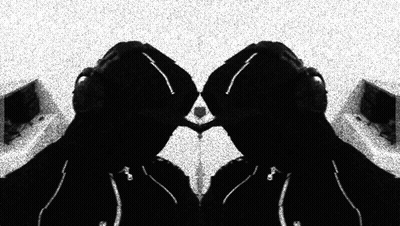 A Black And White Photo Of A Person With Headphones On GIF