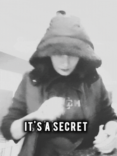 A Black And White Photo Of A Person With The Words " It 'S A Secret " GIF