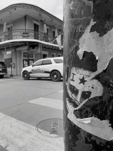 A Black And White Photo Of A Police Car With A Sticker On It That Says I Am Damaged GIF
