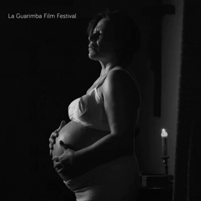 A Black And White Photo Of A Pregnant Woman With La Guarimba Film Festival Written On The Bottom GIF