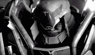 A Black And White Photo Of A Robot Wearing A Helmet And Armor . GIF