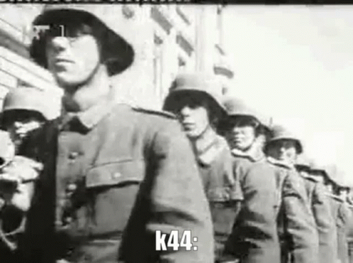 A Black And White Photo Of A Row Of Soldiers Marching In A Parade . GIF