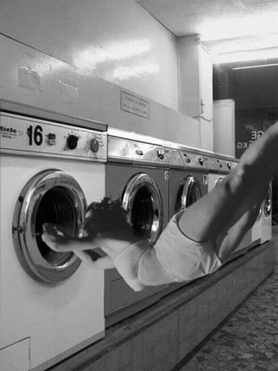 A Black And White Photo Of A Row Of Washing Machines With The Number 16 On Them GIF
