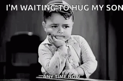 A Black And White Photo Of A Sad Little Boy Sitting At A Table . GIF