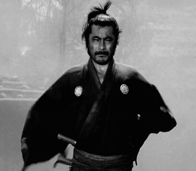 A Black And White Photo Of A Samurai Holding A Sword In His Hand . GIF
