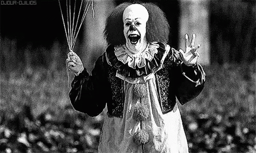 A Black And White Photo Of A Scary Clown Holding A Bunch Of Balloons . GIF