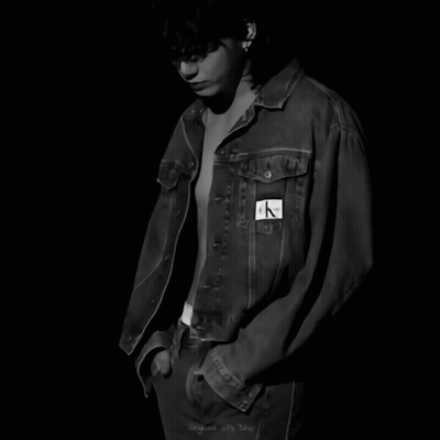 A Black And White Photo Of A Shirtless Man Wearing A Calvin Klein Denim Jacket GIF