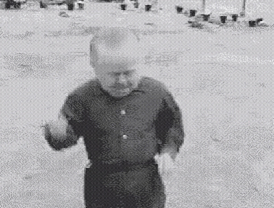 A Black And White Photo Of A Small Man Dancing . GIF