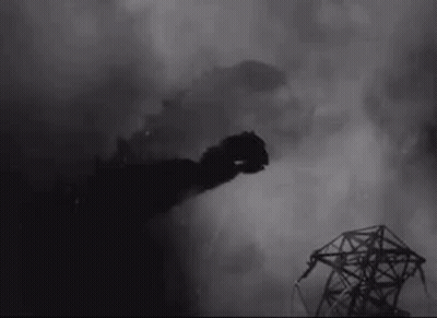 A Black And White Photo Of A Smoke Coming Out Of A Building . GIF