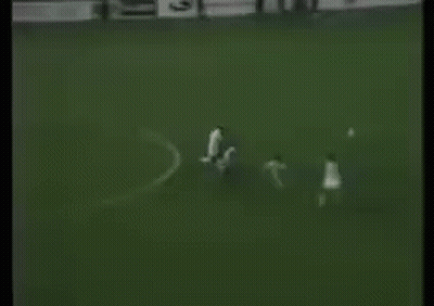 A Black And White Photo Of A Soccer Game With A Goalie In The Background . GIF