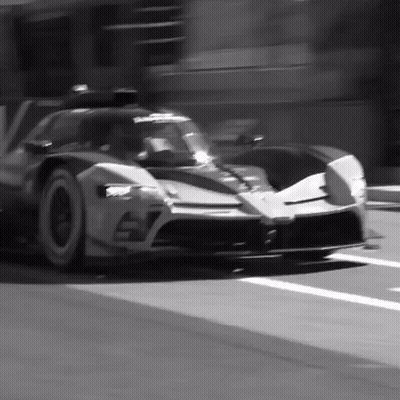 A Black And White Photo Of A Sports Car With The Number 57 On It GIF