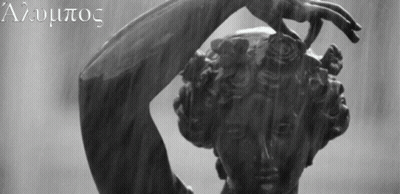 A Black And White Photo Of A Statue Of A Woman With The Letters A And U On The Bottom Right GIF