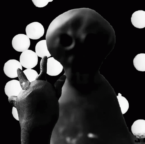 A Black And White Photo Of A Statue With A Thumbs Up GIF