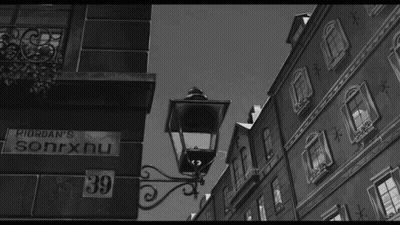 A Black And White Photo Of A Street With A Sign That Says Riordan 'S Sonrxnu GIF