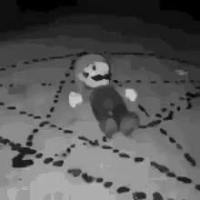 A Black And White Photo Of A Stuffed Mario Sitting In A Circle . GIF