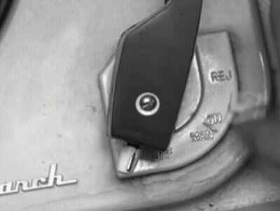 A Black And White Photo Of A Switch That Says " Reu " On It GIF