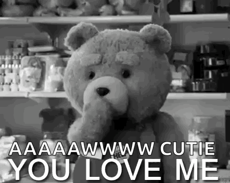 A Black And White Photo Of A Teddy Bear With The Words `` You Love Me '' Written Below It . GIF