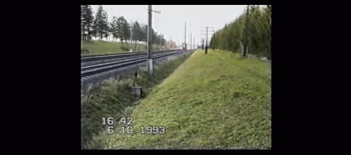 A Black And White Photo Of A Train Track With The Time 16:42 On The Bottom GIF