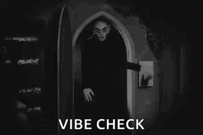 A Black And White Photo Of A Vampire In A Doorway . GIF