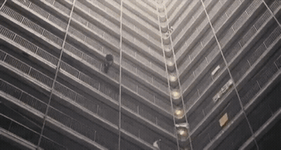 A Black And White Photo Of A Very Tall Building With The Letters Eee On The Side GIF