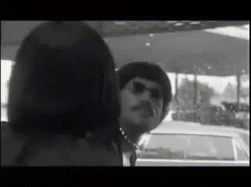 A Black And White Photo Of A Woman And A Man GIF