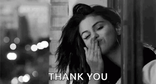A Black And White Photo Of A Woman Blowing A Kiss With The Words `` Thank You '' . GIF