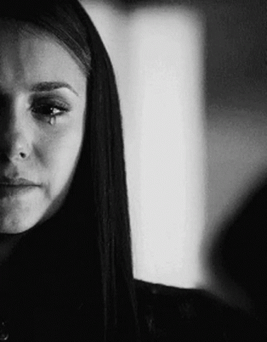 A Black And White Photo Of A Woman Crying With A Tear Running Down Her Face . GIF