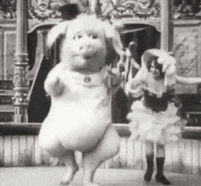 A Black And White Photo Of A Woman Dancing With A Stuffed Animal . GIF