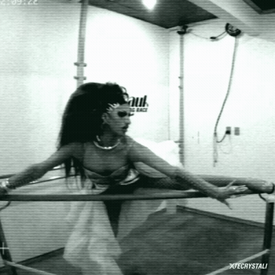 A Black And White Photo Of A Woman Holding A Bar With Xtecrystali Written On The Bottom Right GIF