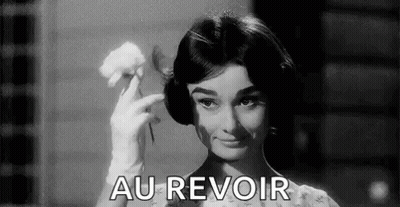 A Black And White Photo Of A Woman Holding A Flower And The Words `` Au Revoir '' . GIF