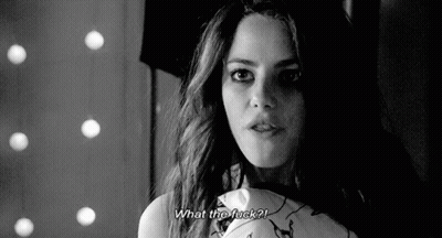 A Black And White Photo Of A Woman Holding A Pillow And Asking What The Fuck ? GIF