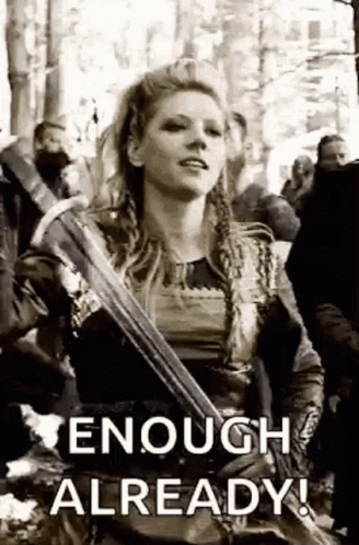 A Black And White Photo Of A Woman Holding A Sword With The Words `` Enough Already '' Written On It . GIF