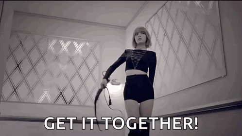 A Black And White Photo Of A Woman Holding A Whip And The Words `` Get It Together ! '' GIF