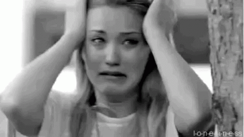 A Black And White Photo Of A Woman Holding Her Head While Crying . GIF