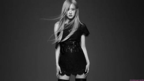 A Black And White Photo Of A Woman In A Black Dress And Thigh High Stockings . GIF
