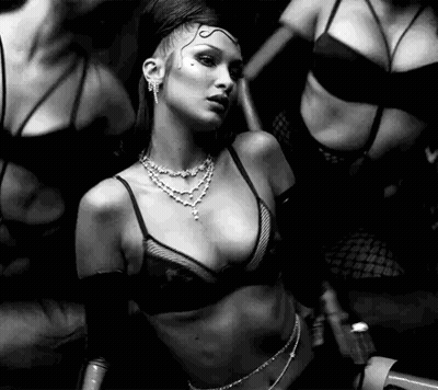 A Black And White Photo Of A Woman In A Bra . GIF