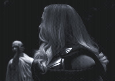 A Black And White Photo Of A Woman In A Costume GIF