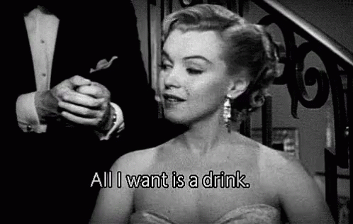 A Black And White Photo Of A Woman In A Dress Saying `` All I Want Is A Drink '' . GIF