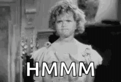 A Black And White Photo Of A Woman In A Dress With The Words `` Hmm '' Written On Her Face . GIF