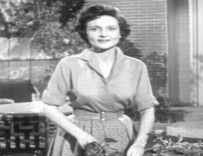 A Black And White Photo Of A Woman In A Polka Dot Dress GIF