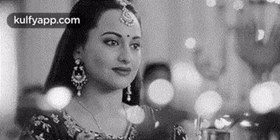 A Black And White Photo Of A Woman In A Traditional Indian Dress . GIF