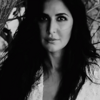 A Black And White Photo Of A Woman In A White Dress GIF