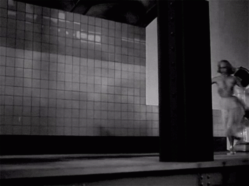 A Black And White Photo Of A Woman In A White Dress Running GIF