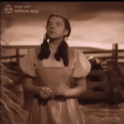 A Black And White Photo Of A Woman In A Yellow Dress GIF